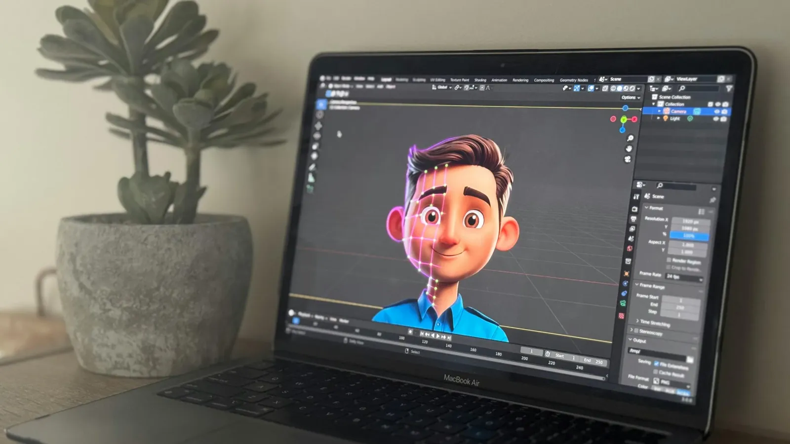 A laptop with graphics rendering software open on the screen. The software is rendering a model of a cartoon man.
